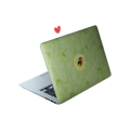 Cottagecore laptop skin featuring a detailed acorn in the center with a background of faint green and brown autumn leaves.