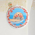 Hand-drawn illustration of a cute otter with the punny text 'Otterly Adorable' on a matte die-cut sticker.