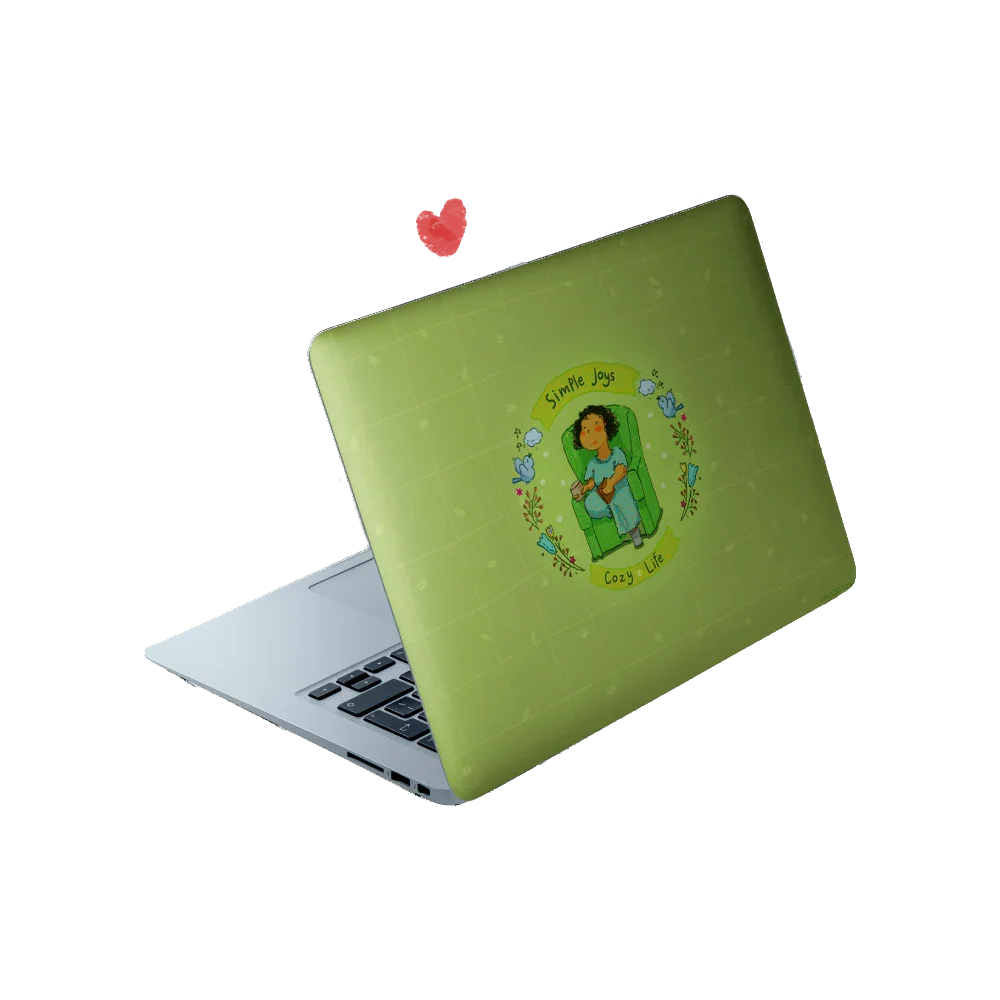 Matte laptop skin with an illustration of a girl reading on a couch with the text 'Simple joys, cozy life'