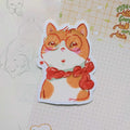 A stylish cat wearing gold earrings and thick-rimmed glasses, illustrated in a cozy matte vinyl sticker style.